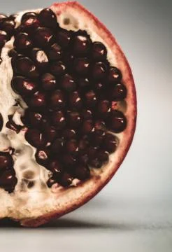 Half pomegranate on a blue background Stock Photos