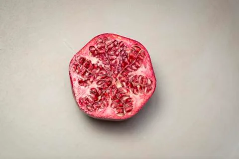 Half a Pomegranate on a grey background Foto stock