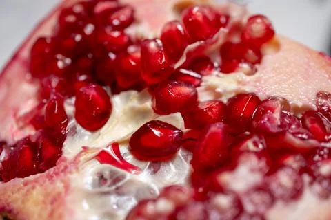 Half pomegranate on rotating background Stock Photos