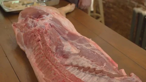 Half Pork Carcass on the table Stock Footage 137900019
