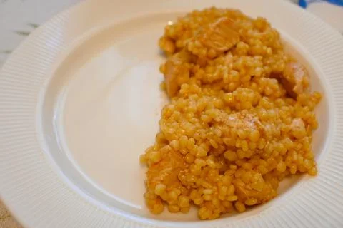 Half portion of a grain-and-chicken meal on a plate Stock Photos