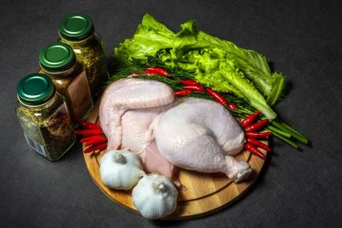 Half a raw chicken served Vegetable, jars of spices, horizontal Stock Photos