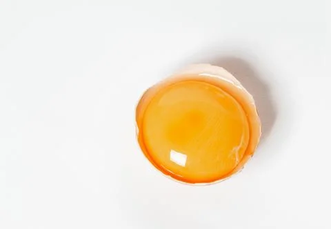 Half raw egg on a light background, close-up, top view. Stock Photos
