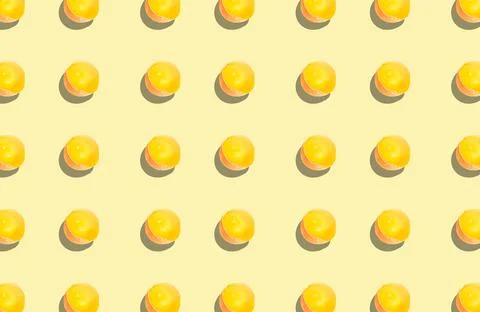 Half a raw egg in a shell with the yolk on a yellow background with a shadow. Stock Photos