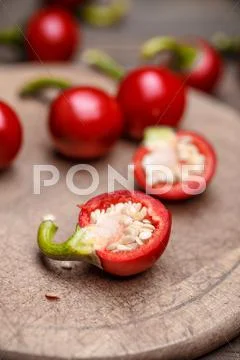 Half red cherry chillis Stock Photos
