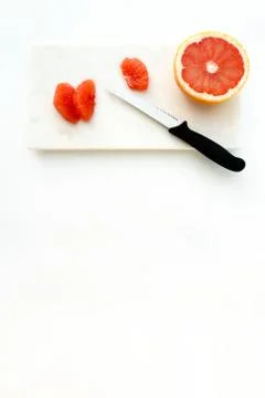 Half of a Red Grapefruit and Grapefruit Fillets Stock Photos
