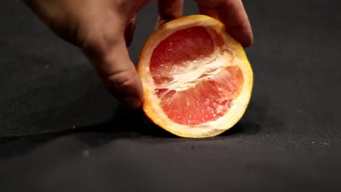 Half red grapefruit on a black background Stock-Footage 97928681