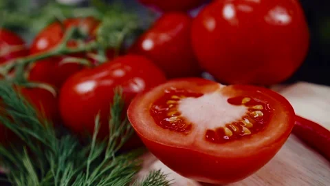 Half of a red ripe tomato is lying on the board, against the background of a Stock Footage 146283179