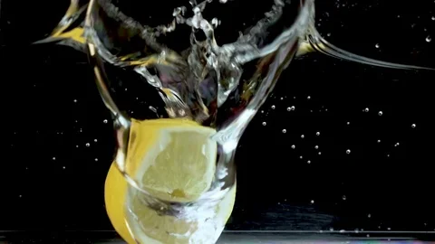 Half a ripe lemon falls in water in slow motion Stock-Footage 111945764