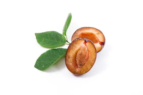 Half of ripe plum with leaf isolated on a white background.. Stock Photos