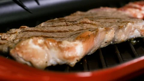 Half roasted steak is lifted up by the fork 스톡 동영상 102611212