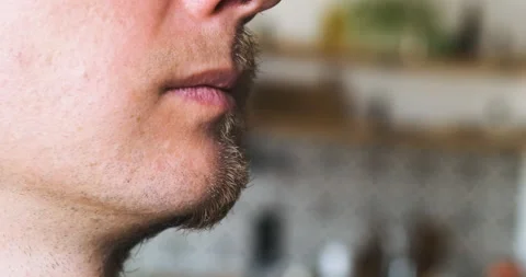 Half-shaven unrecognizable man. The face, close-up, turns, a shadow falls on the Stock Footage 202243662