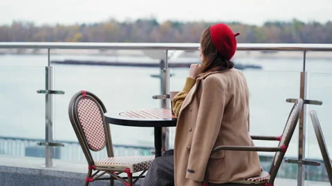 Half-side frame of a french young woman in red beret, wearing a stylish coat Stock Footage 147119086
