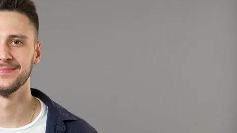 Half side portrait of attractive bearded man wearing casual clothes smiling at Video stock 89702559