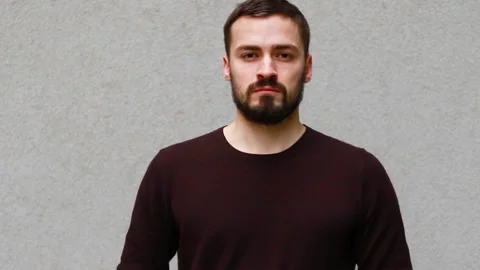 Half side portrait of attractive bearded man wearing casual clothes smiling Video stock 107387140