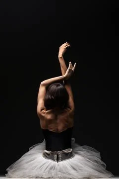 Half silhouette modern ballet dancer. Balerina posing on dark background Stock Photos