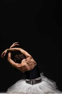 Half silhouette modern ballet dancer. Balerina posing on dark background Stock Photos