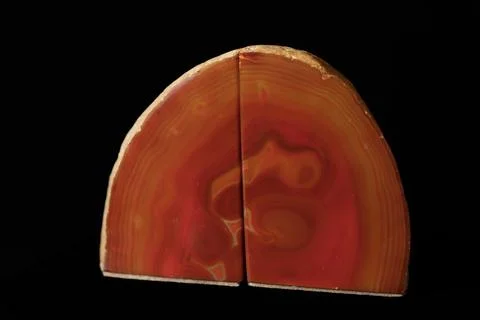 Half-slice agate with warm red and orange bands Stock Photos