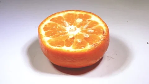 Half slice of orange lemon isolated on a white background rotate 360-degree s Stock Footage 168020402