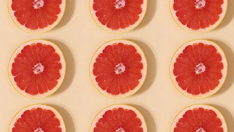 Half sliced citrus grapefruit pattern rotating. Stop motion flat lay Stock Footage 153176529