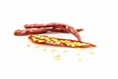 Half sliced dried chilli pepper with raw material Stock Photos