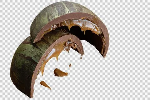 Half a sliced Easter egg with double shell stuffed with melted caramel and .. Stock Photos