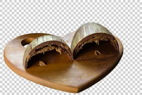 Half a sliced Easter egg with double shell stuffed with caramel and cookies. Stock Photos