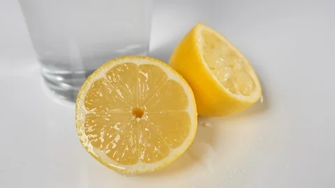 Half of a sliced fresh lemon citrus fruit with a squeezed yellow and water  Stock Footage 88511100