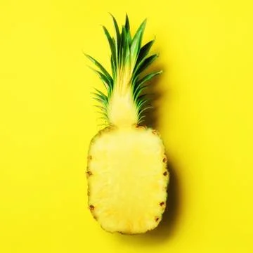 Half of sliced pineapple on yellow background. Top View. Copy Space. Bright Stock Photos