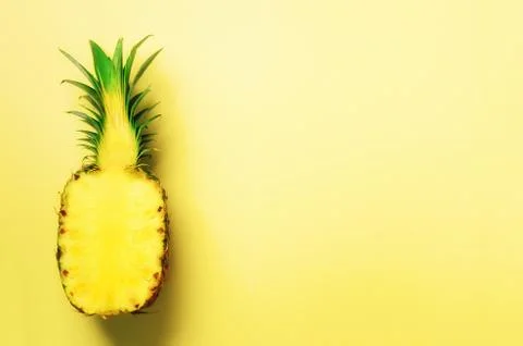 Half of sliced pineapple on yellow background. Top View. Copy Space. Bright Stock Photos