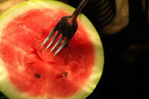 Half sliced watermelon with fork Stock Photos