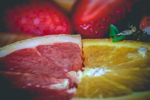 Half slices of ruby red grapefruit and orange Stock Photos