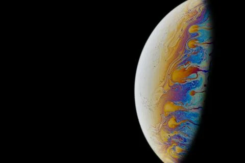 Half a soap bubble. Colorful patterns. Close-up. Science fiction. Stock Photos