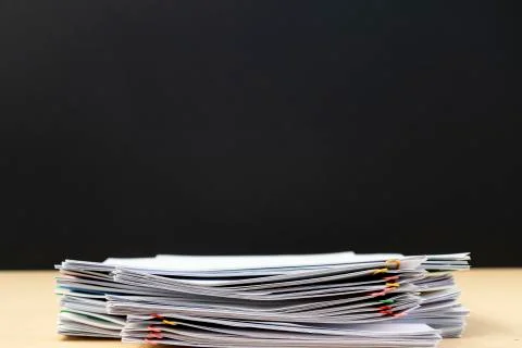Half of Stack of document paper with colorful paperclip place on wooden table Stock Photos