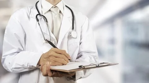 A half-standing doctor, without a face, holding a stethoscope against a whi.. Stock Photos
