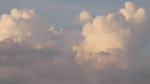 Half sunlit Fluffy Clouds moving close-up timelapse Stock Footage 157313228