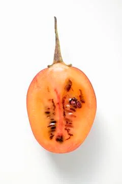 Half a tamarillo (overhead view) Stock Photos