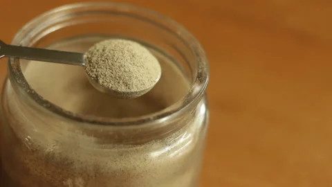 A half teaspoon of finely white ground pepper powder is being scooped Stock Footage 222690532