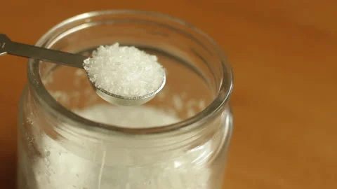 A half teaspoon of white refined MSG monosodium glutamate powder Stock Footage 222696777