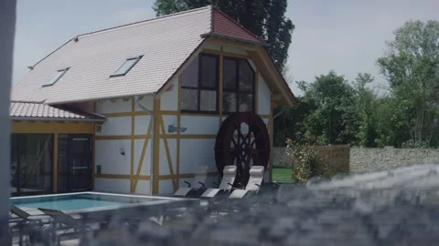 Half Timbered House With Mill Wheel and Pool, Sunny Garden Wide Shot Video stock 341423039