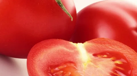 Half a tomato in front of whole tomatoes Stock Footage 8574203