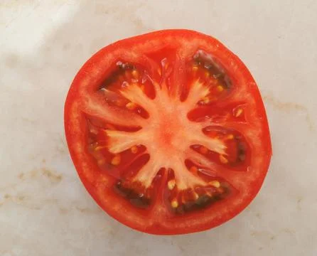 Half tomato on marble background Stock Photos