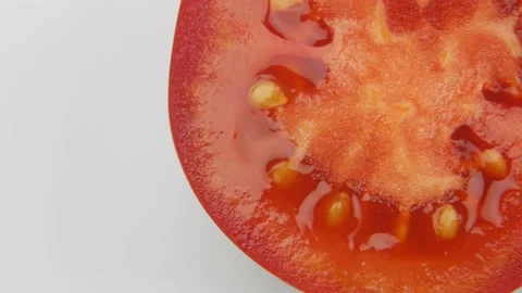 Half a tomato spins on a white background. Place for text Video stock 138894913