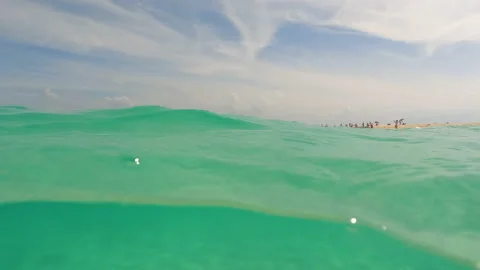 Half underwater, blurry turquoise ocean waves, sandy beach on tropical island Stock Footage 195123429