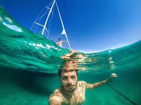 Half underwater selfie infront of boat, happy summer time with firend. Stock Photos