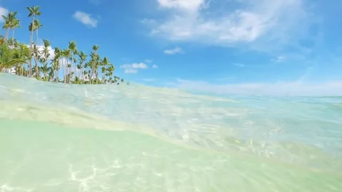 Half underwater slow motion clear turquoise sea water at the tropical beach in Stock Footage 243187257