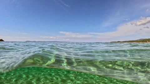 Half underwater slow-motion shot of tropical beach with crystal clear sea water Stock-Footage 252284497
