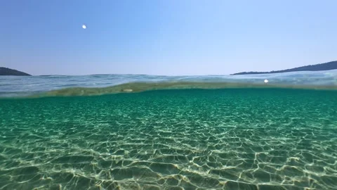 Half underwater slow motion turquoise sea water at the exotic sandy beach Stock Footage 278797018