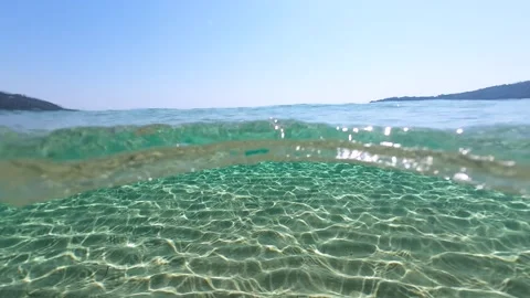 Half underwater slow motion turquoise sea water at the exotic sandy beach Stock Footage 278797020