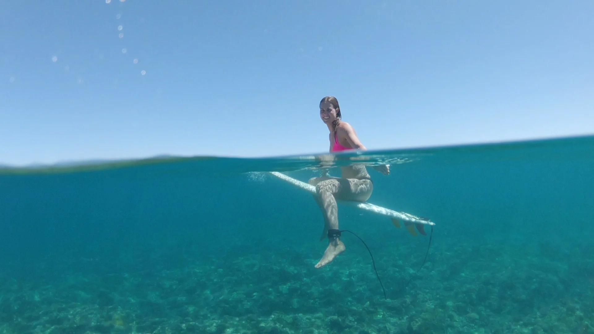 Half Underwater Smiling Surfer Girl In Bikini Looks Around The